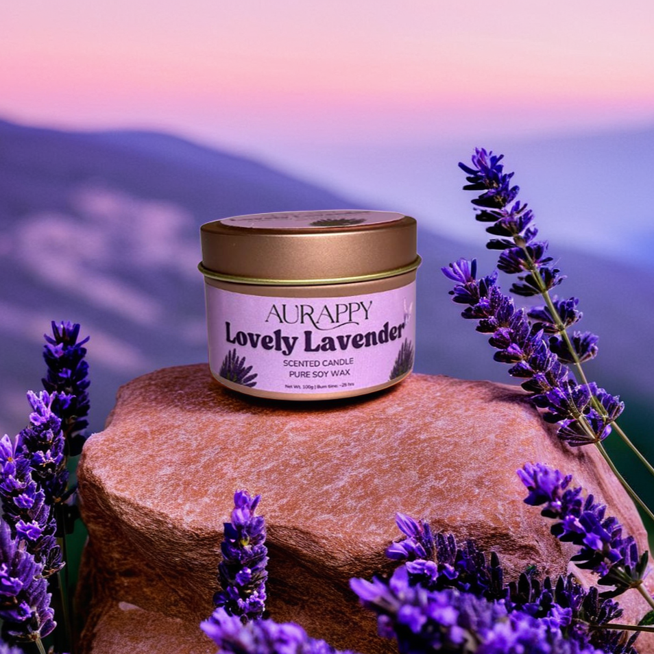 Aurappy Lovely Lavender tin candle on rock with lavender flowers – calming aromatherapy gifting India