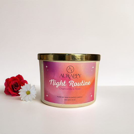 Aurappy candle with a pink label featuring a rose and chamomile on a light pink background