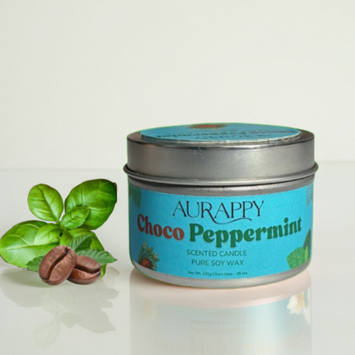 Aurappy Choco Peppermint scented candle in a tin with a leaf and peppermint on a light background
