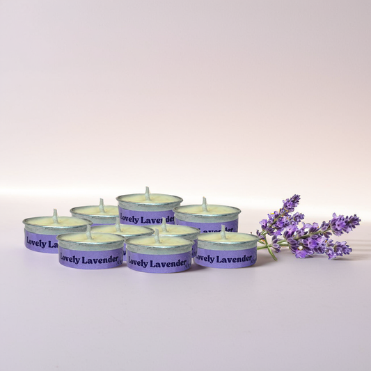Set of 'Lovely Lavender' Tealight candles with a sprig of lavender on a white background