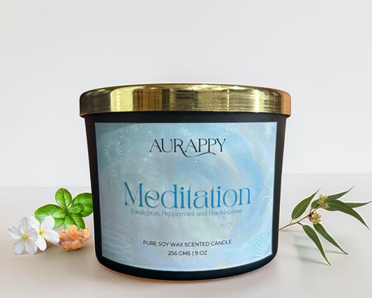 Aurappy Meditation candle with a gold lid on a light background
