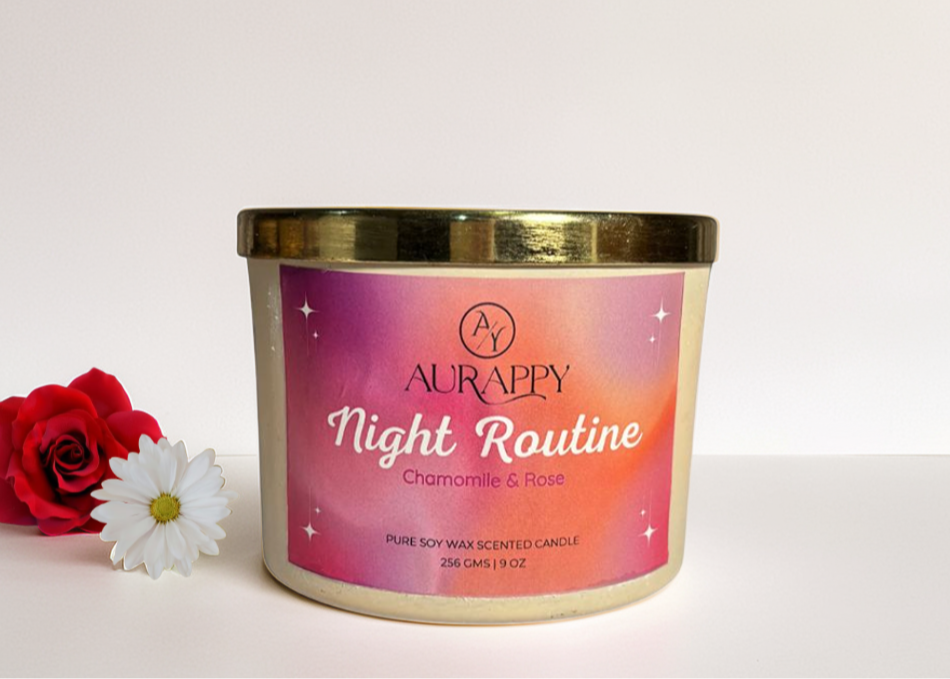 Aurappy candle with a pink label featuring a rose and chamomile flower on a light pink background