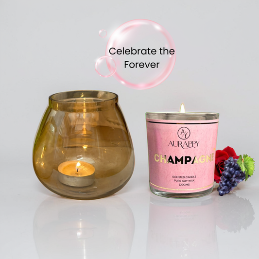 Two candles, one in a glass holder and the other in a pink container labeled 'Champagne', with decorative elements on a light background.
