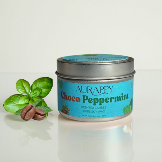 Aurappy Choco Peppermint scented candle in a tin with a leaf and peppermint on a light background