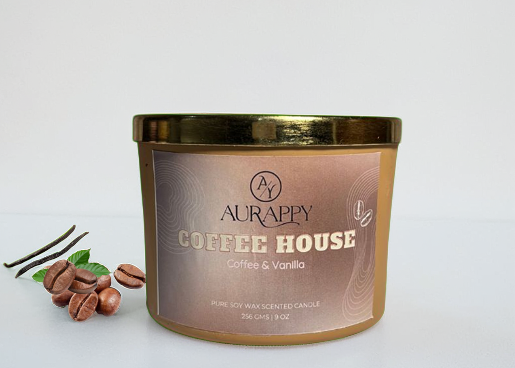 Aurappy Coffee House candle with coffee beans and vanilla leaves on a white background